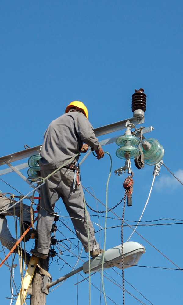 low-angle-shot-electric-linemen-working-